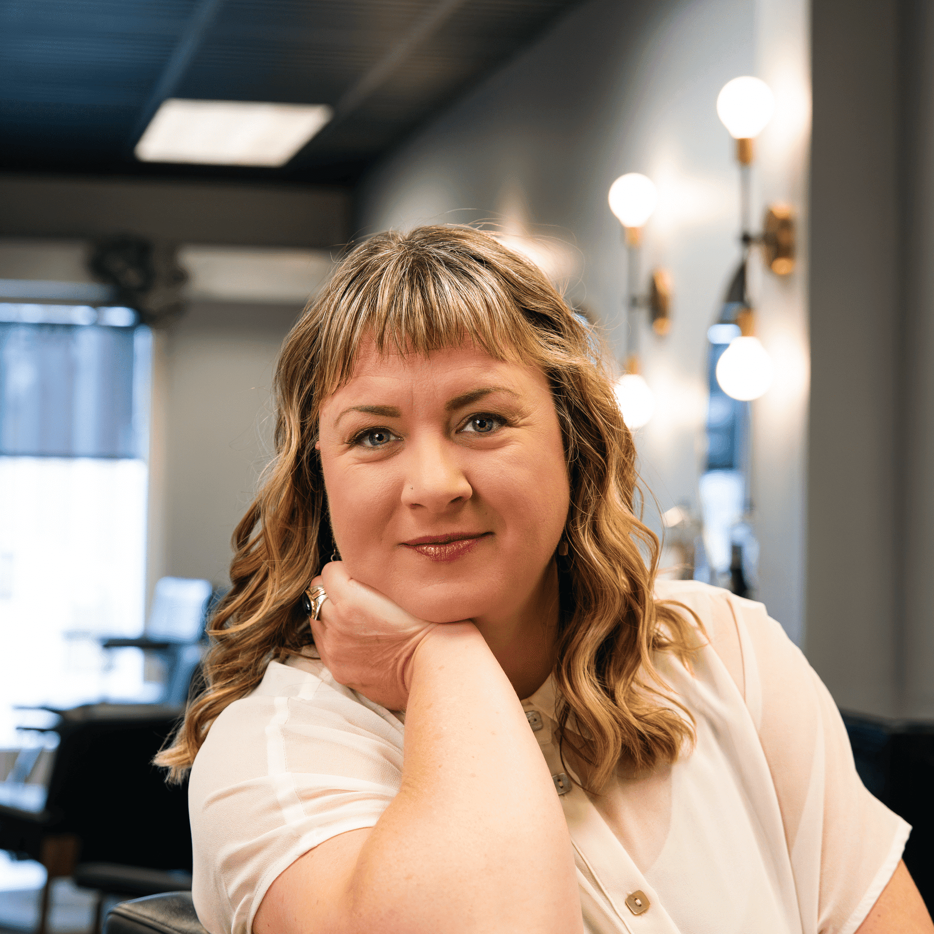Portrait of Darcy Taylor, a professional stylist at Salon Enso, showcasing their expertise and style.