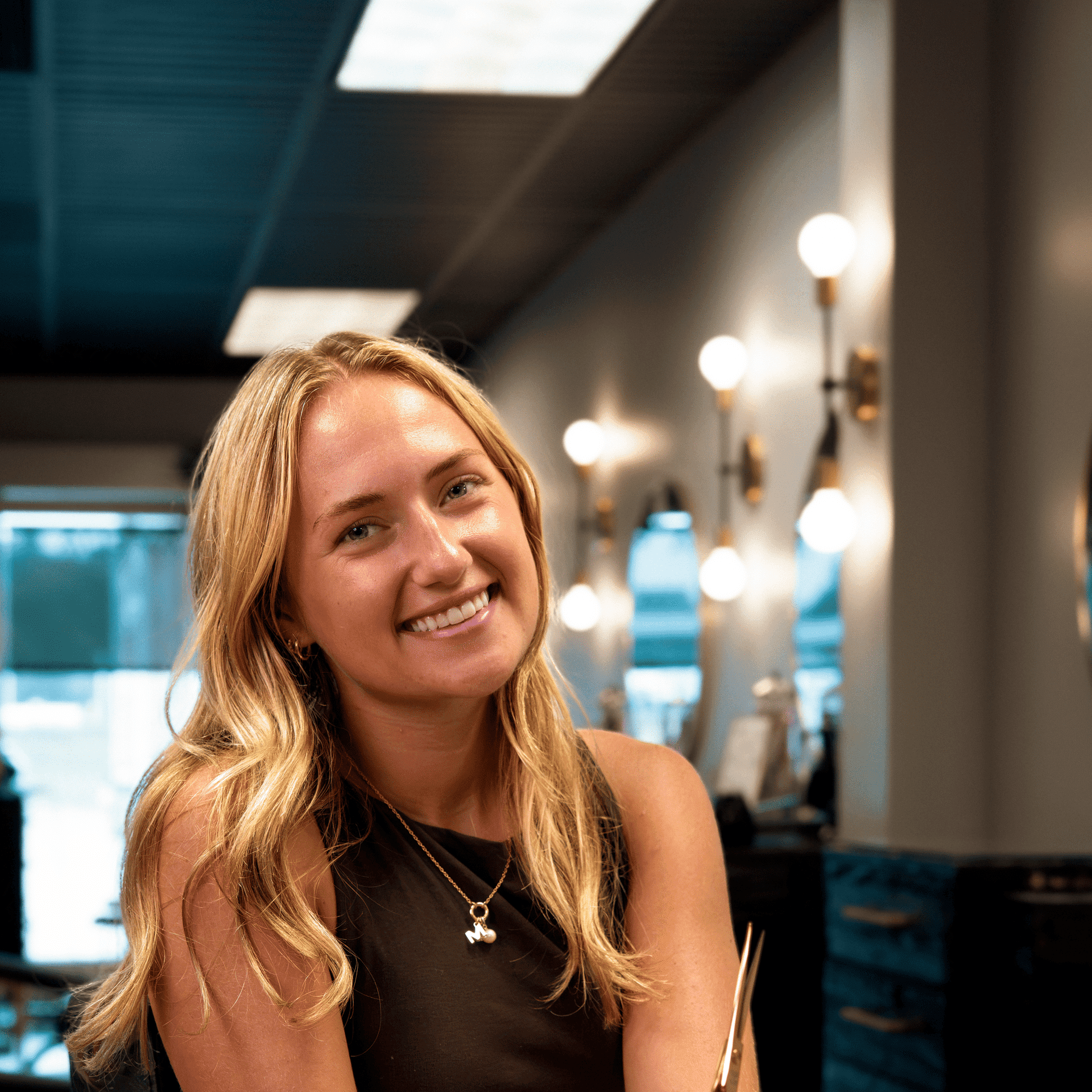 Portrait of Hailey Nelson, a professional stylist at Salon Enso, showcasing their expertise and style.