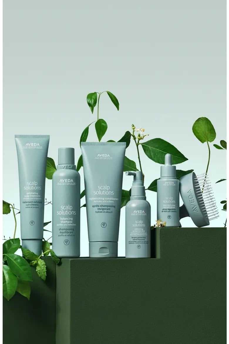 Aveda Scalp Solutions product lineup with greenery background.