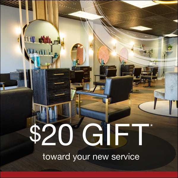 Salon interior with mirrors and chairs; $20 gift toward your new service offer.